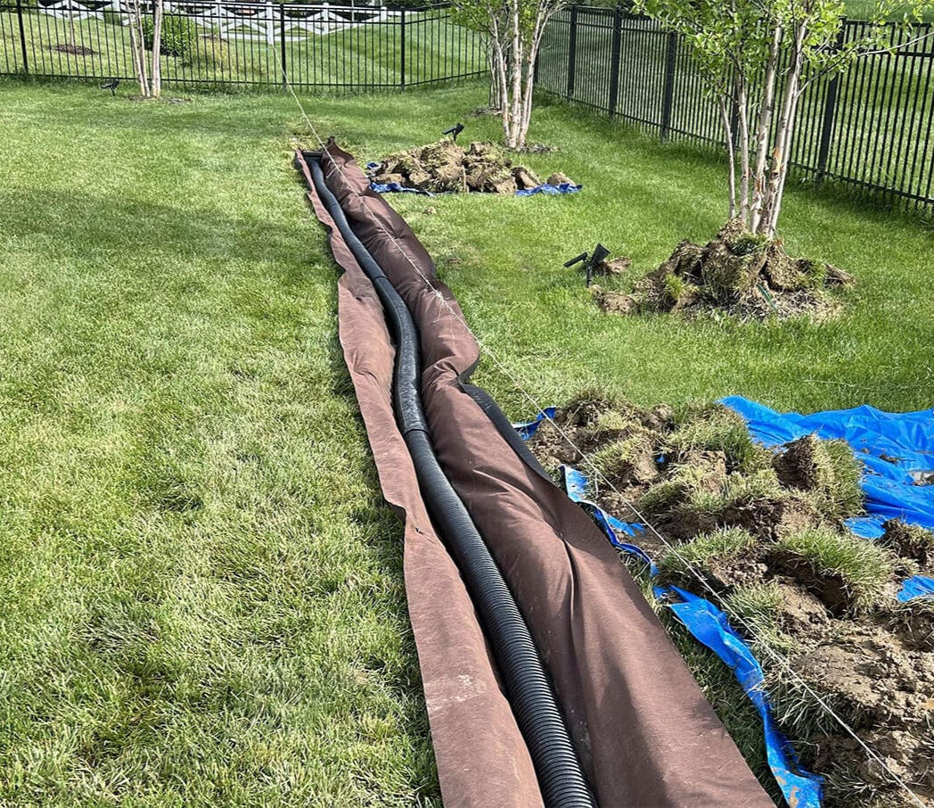 Residential French drain installation in Hallsville, Texas. Drainage and irrigation solutions to prevent flooding and protect East Texas homes.