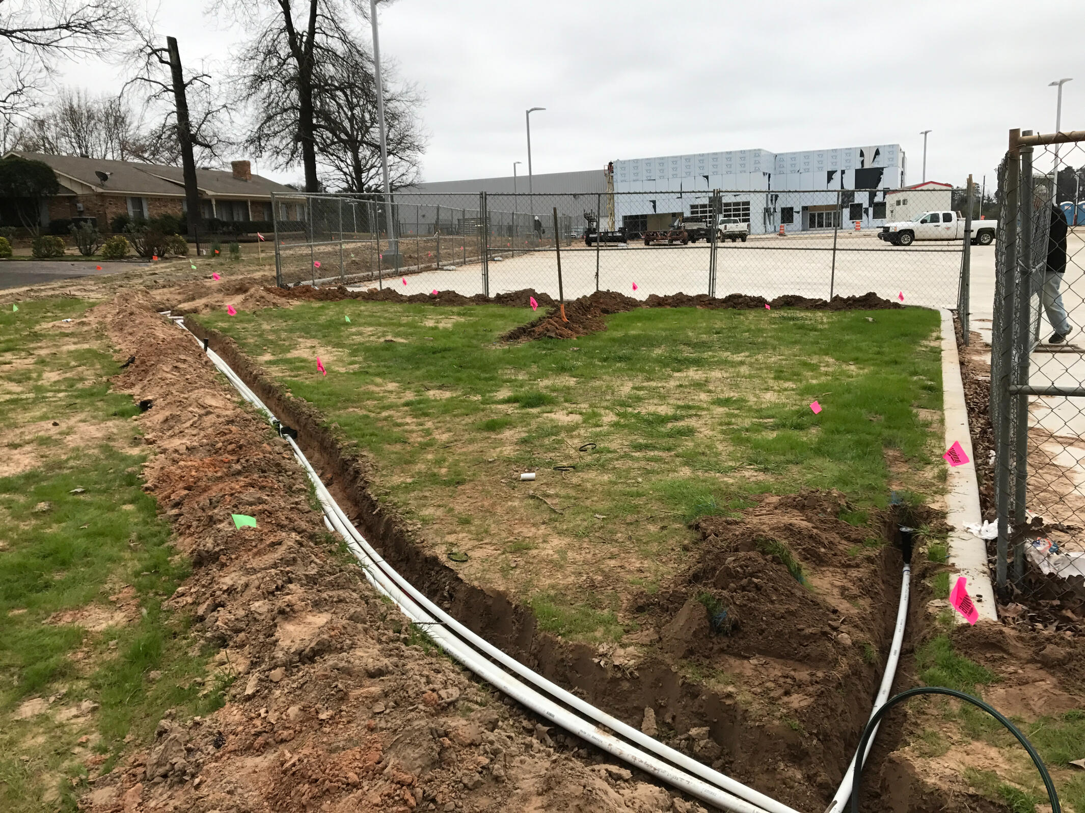 Hans de Jong Irrigation Company Commercial multi-line PVC irrigation trench installation in Longview, Texas. Advanced irrigation system construction for large East Texas properties.